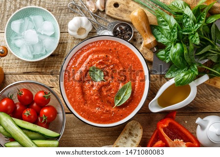 Gazpacho soup. Traditional spanish cold tomato soup of fresh raw vegetables with cooking ingredients on a wooden table top view Royalty-Free Stock Photo #1471080083