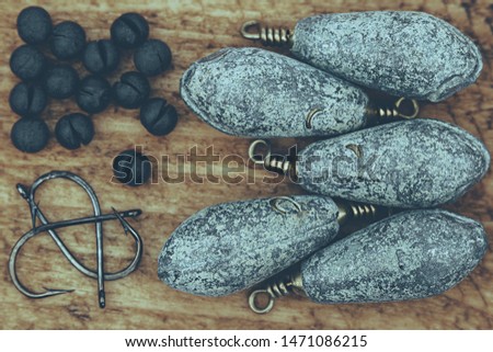 Various fishing items arranged on wooden background