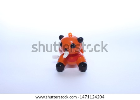 tiny colorful toy on white backdrop