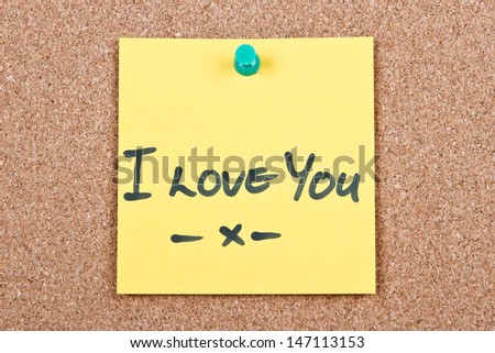 Post it note on wood in yellow with I love you
