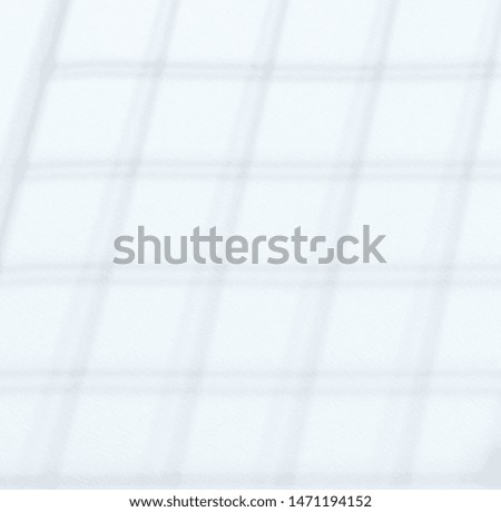 Square net shadow on white wall background close up view