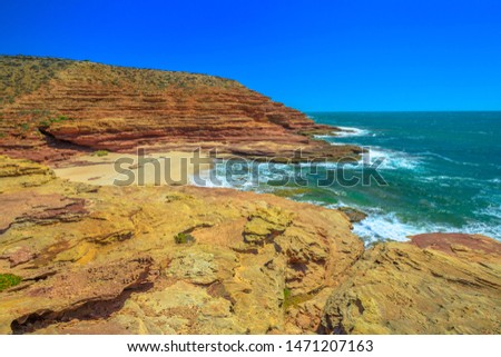 Scenic aerial view of Pot Alley in Kalbarri National Park, Western Australia from Pot Alley lookout. Rugged sandstone, Coral coast in turquoise Indian Ocean. Blue sky with copy space.