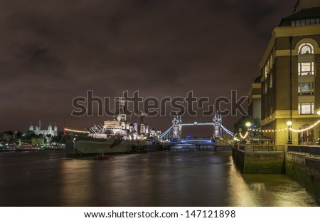 HMS Belfast on the river Thames  and Tower bridge at night