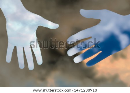 silhouette hands of sky against dark clouds,concept of help,care,love or assistance,abstract composite image