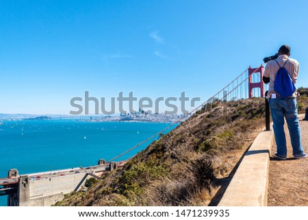San Francisco, California. Golden Gate Bridge. Man/ Photographer/ Tourist taking picture of the iconic landmark from Battery Spencer near Sausalito city in Marin County opposite the city Bay Area.