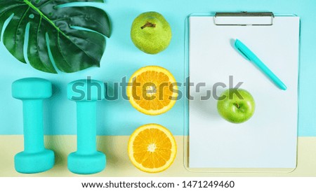 Health and fitness concept flatlay with exercise equipment on modern colorful background.