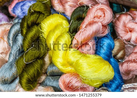 The silk yarn is obtained from a silkworm, Household handicrafts of Thai silk use for weaving traditional Thai silk. Weaving loom for homemade silk 