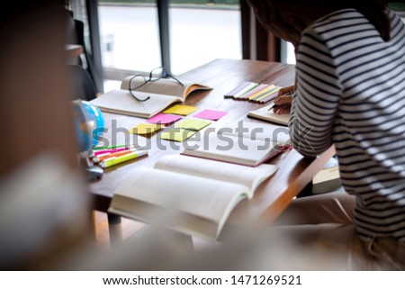 woman and man work for education or business on the table with notebook laptop and paper work color pen, in the libary room