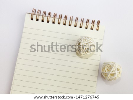Blank notepad for writing with white wooden balls. Closeup.