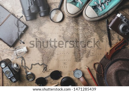 Travel Concept Background. Overhead View of Traveler's Accessories on Old Vintage Map Royalty-Free Stock Photo #1471285439