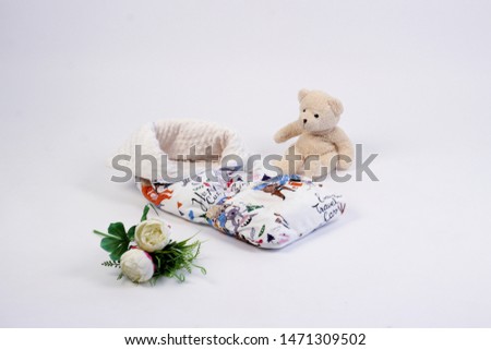 textiles for newborns in the photo Studio on a white background, the side of the pillow in a baby bed, blankets are transformed into envelopes for a walk, a cocoon for a comfortable and safe sleep of 