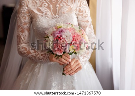 Bride in white wedding dress holding wedding bouquet