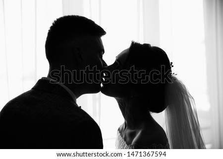 Wedding couple. Black and white photo, Silhouete of kissing bride and groom