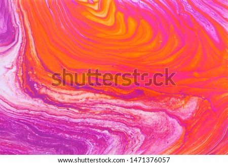 photography of abstract marbleized effect background. red, pink, orange and white creative colors. Beautiful paint.