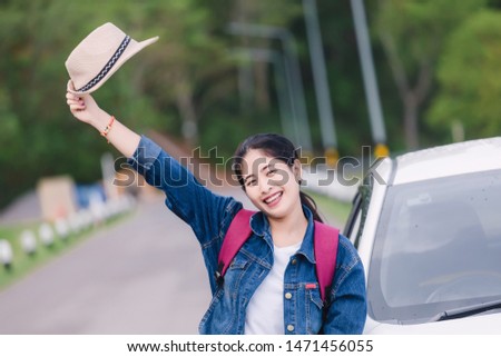 Relaxed happy woman on summer roadtrip travel vacation looking  at nature view out car window