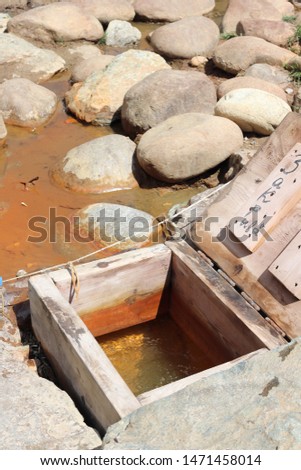 A well with sparkling mineral water in the Caucasus mountains. A natural source of healing, drinking mineral water. Translation of the inscription from Russian "Close"