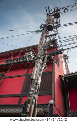 Overhead power lines and old red building in the Gion District of Kyoto, Japan