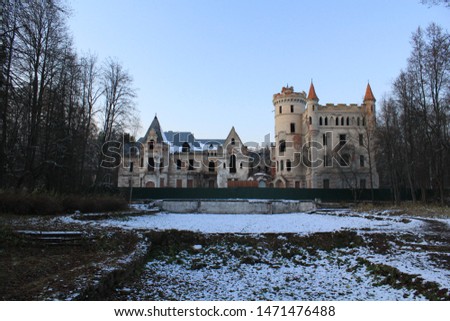 Winter landscape with crumbling castle on the background of grass covered with snow Royalty-Free Stock Photo #1471476488
