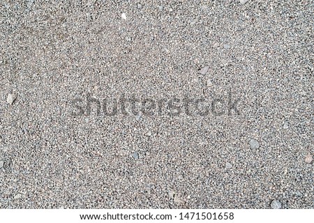 Gravel texture. Fine light gray stone gravel. Natural textural background.