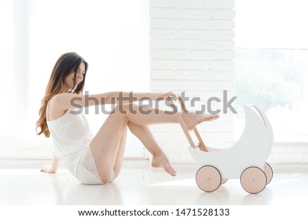 Beautiful young woman with baby stroller. Concept photo.