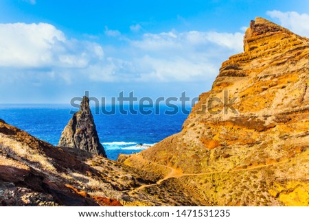 The blinding midday sun. The west coast of the island of Madeira - the bay between the rocks. Madeira is island in the Atlantic. The concept of active, ecological and photo tourism