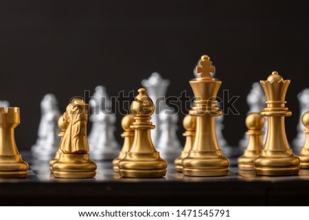 Gold and silver chess group on the board