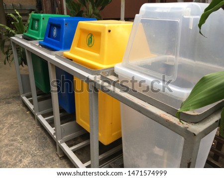Colorful garbage bins for waste segregation.