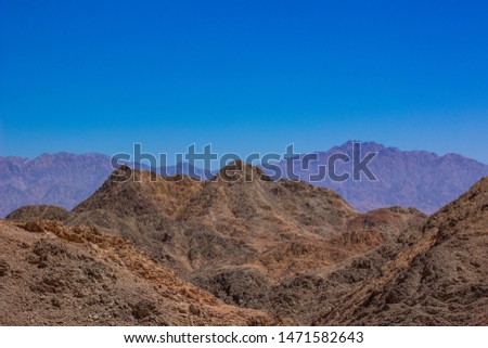 steep and sharp rocky mountain desert wilderness scenery landscape wallpaper pattern picture with empty blue sky background and space for copy or text 