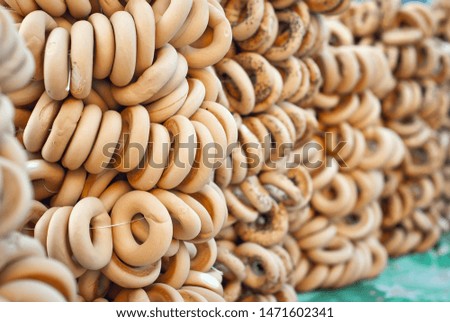 Many different bagels are sold at the city fair. Wheat products are tied with rope.