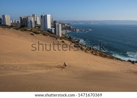 Sandboarding next to Concon, Chile Royalty-Free Stock Photo #1471670369