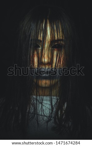 Scary witch with black eyes on dark background. Poster for a horror movie