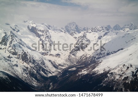 Insanely beautiful and atmospheric view of the Caucasus Mountains covered with glaciers near the ski resort Dombay, Karachay-Cherkessia, Russia.