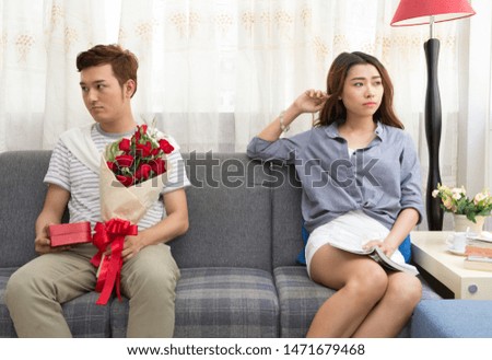 Image of young man quarreling with his wife at home while screaming and scolding his wife, family concept