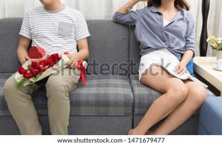 Image of young man quarreling with his wife at home while screaming and scolding his wife, family concept