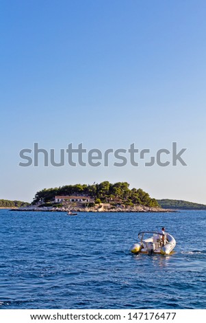 Boats On The Sea With Island On Back. High quality stock photo.