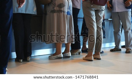 Close-up of women and man waiting in queue in the hospital or post. Media. People waiting quietly for their turn