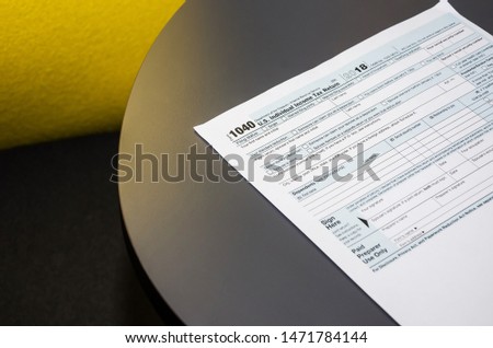 tax form 1040 on a gray table in the office