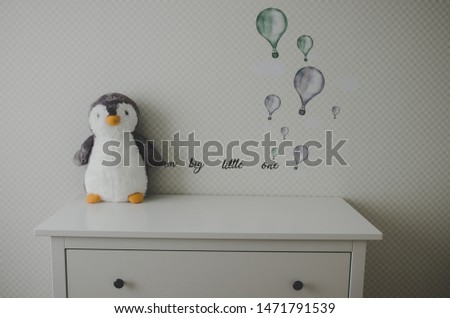 baby nursery with penguin toy 