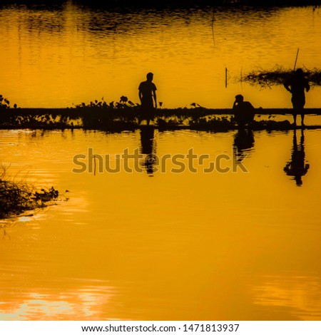 A man fishing in the yellow sunset in Myanmar