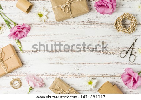 Gifts; flowers and scissor arranged in circular pattern on table