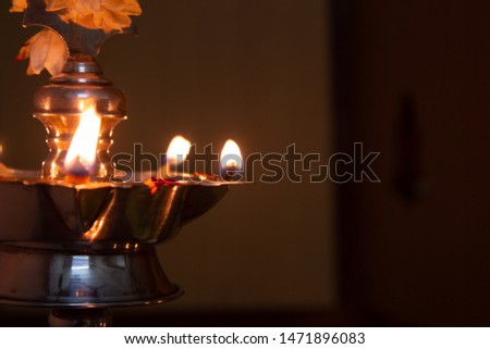 Lit lamps during the prayers to god offering food during indian festival
