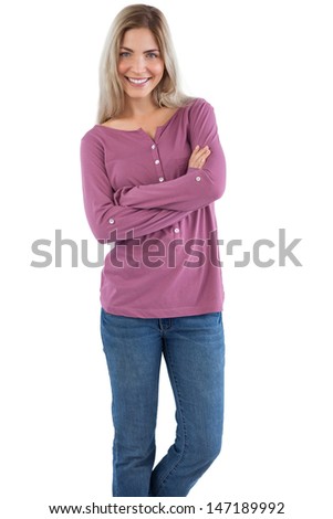 Smiling woman with arms crossed on a white background