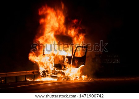 Burning truck on the highway Royalty-Free Stock Photo #1471900742