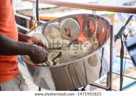 man is playing on a steel drums at cruise ship open deck Royalty-Free Stock Photo #1471901825