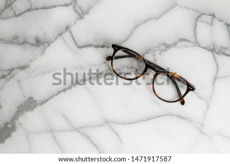 Tortoise Shell Glasses on Marble Background, Copy Text
