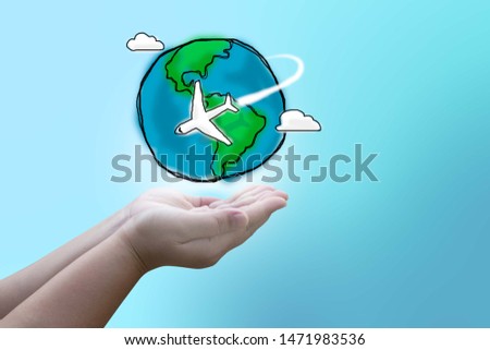 Hand holding Flying Plane. The path Plane. Flying around the world. Hand drawing