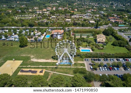Aerial photography. Beautiful coastline. In the city of Bardolino, Lake Garda is the north of Italy. View by Drone. Ferris wheel.