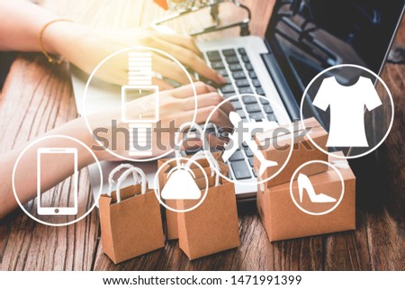 shopping online at home concept.Cartons in a shopping cart on a laptop keyboard.online shopping is a form of electronic commerce that allows consumers to directly buy goods from a seller over internet