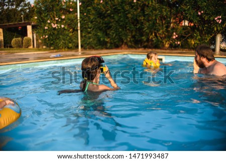 Dad with daughter and son in the pool