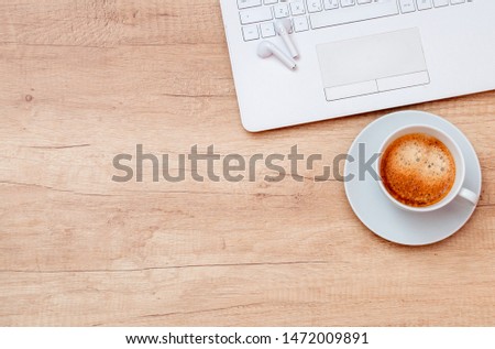 Coffee, laptop and headphones on wooden table. Relax concept